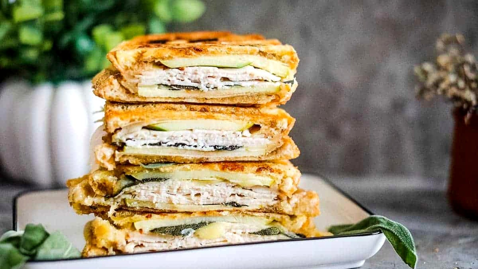Turkey & Apple Panini stacked on a plate.