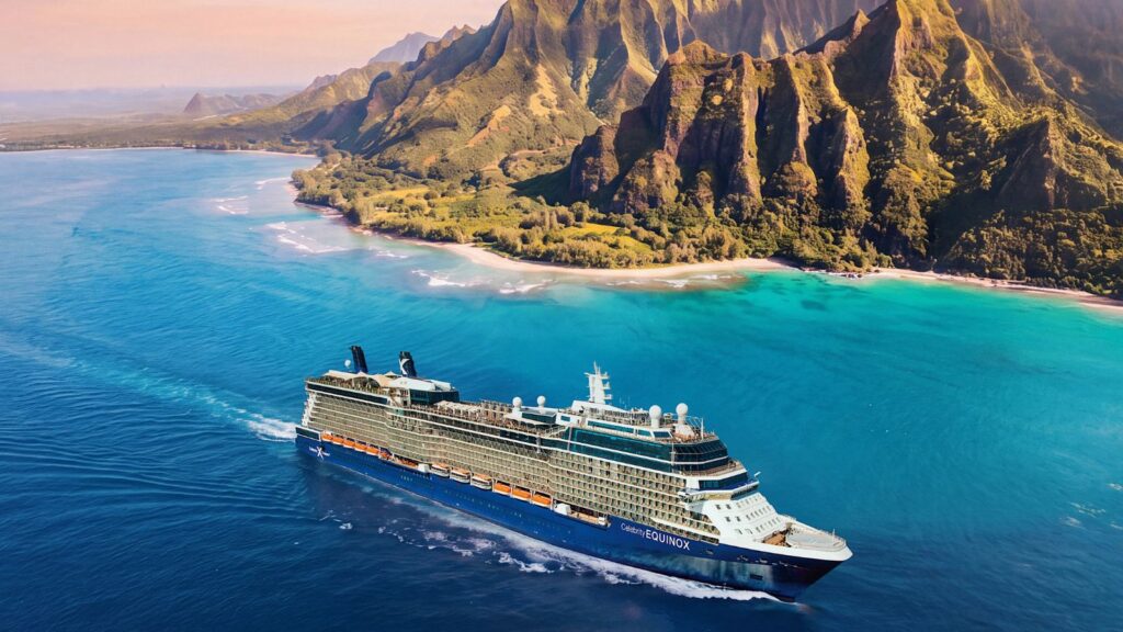 A large Celebrity Cruises ship sails near a lush, mountainous coastline with clear blue water and a white sandy beach under a pink sky, offering a glimpse of the unforgettable journeys planned for 2028 and 2029.