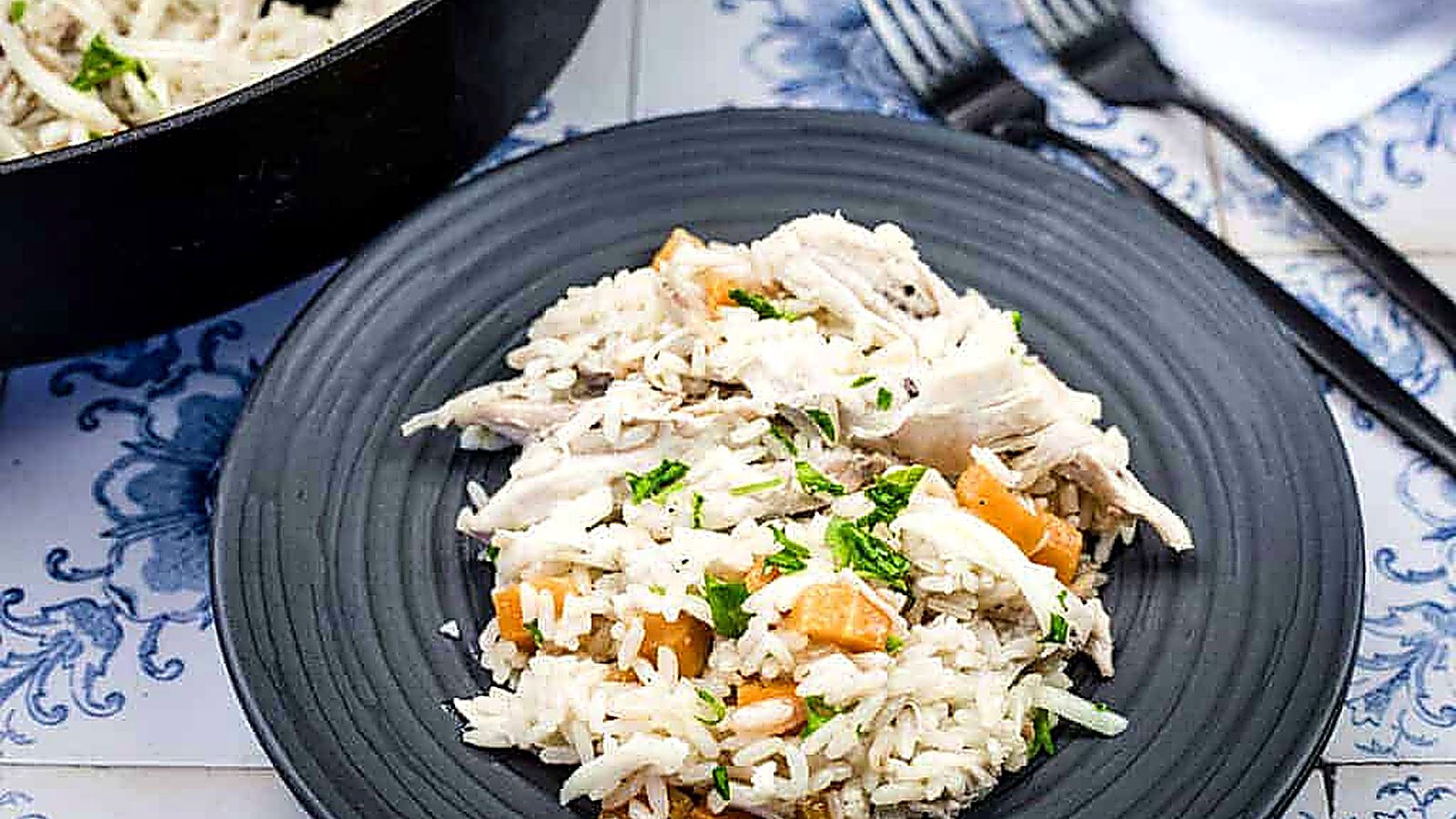 A black plate with a serving of Chicken Bog.