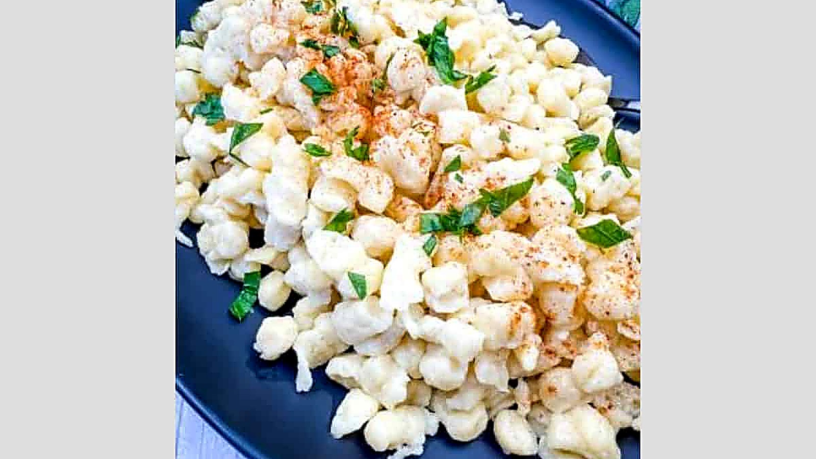 A plate of Authentic German Spaetzle garnished with parsley.