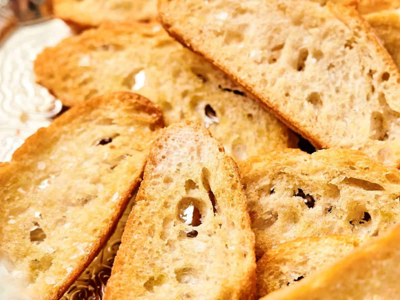 Slices of toasted bread stacked together.