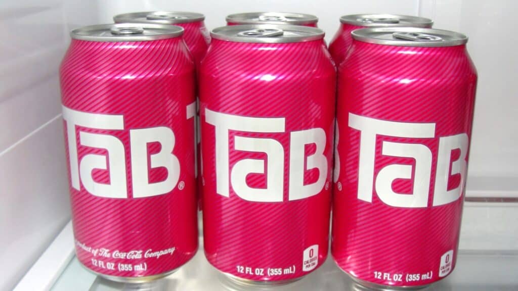 Six pink cans of Tab soda, each 12 fl oz (355 ml), are arranged in two rows inside a refrigerator&mdash;a nostalgic nod to sodas that had their moment.