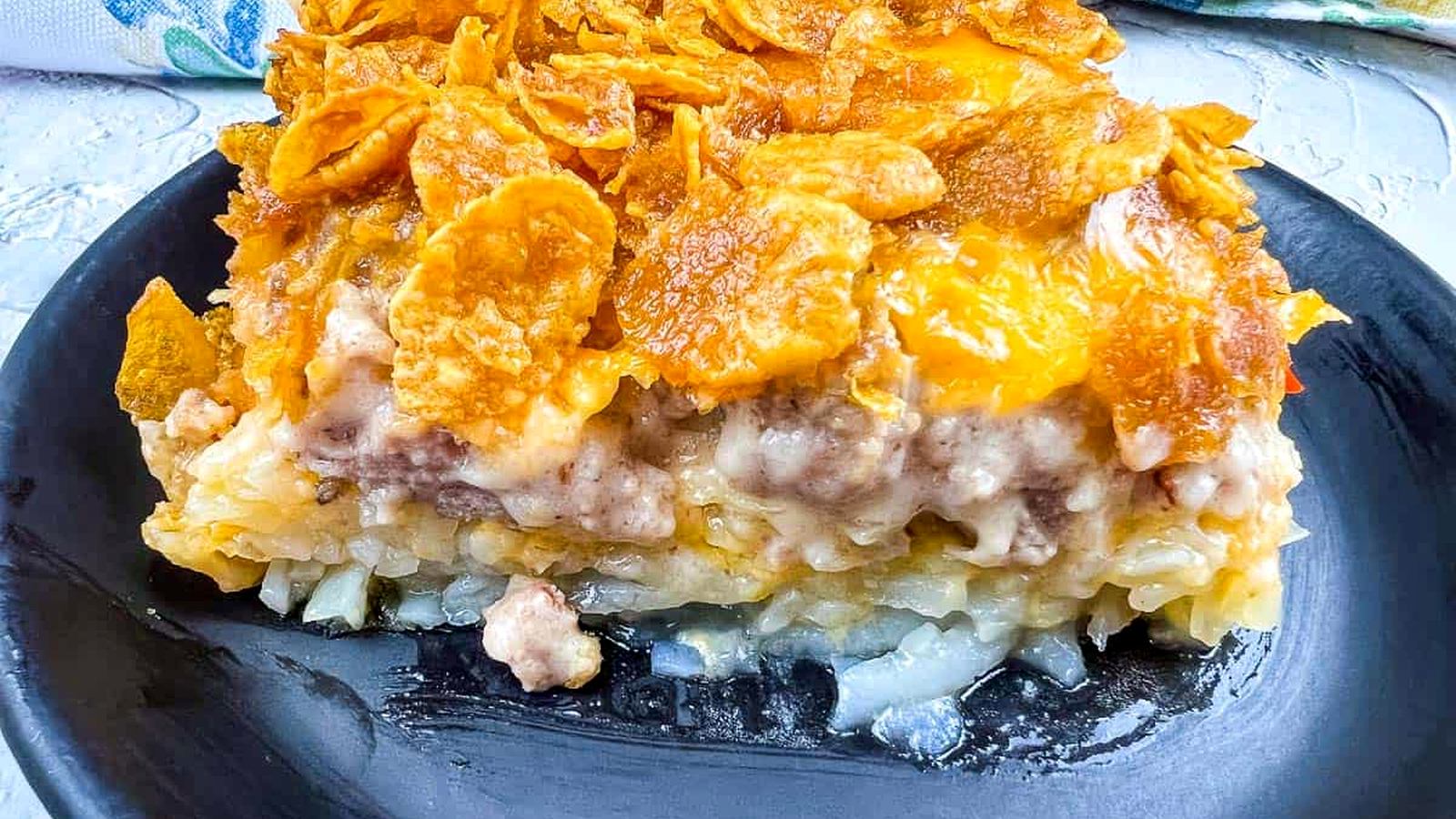 A plate of breakfast casserole on a black plate.