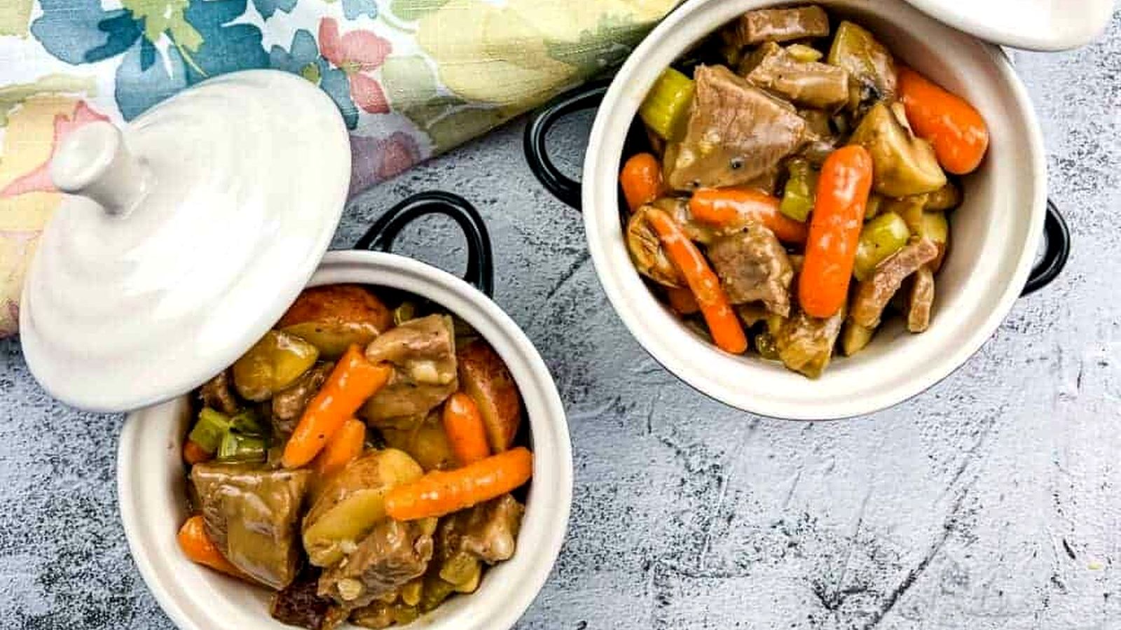 Two bowls of leftover roast beef stew on a table.