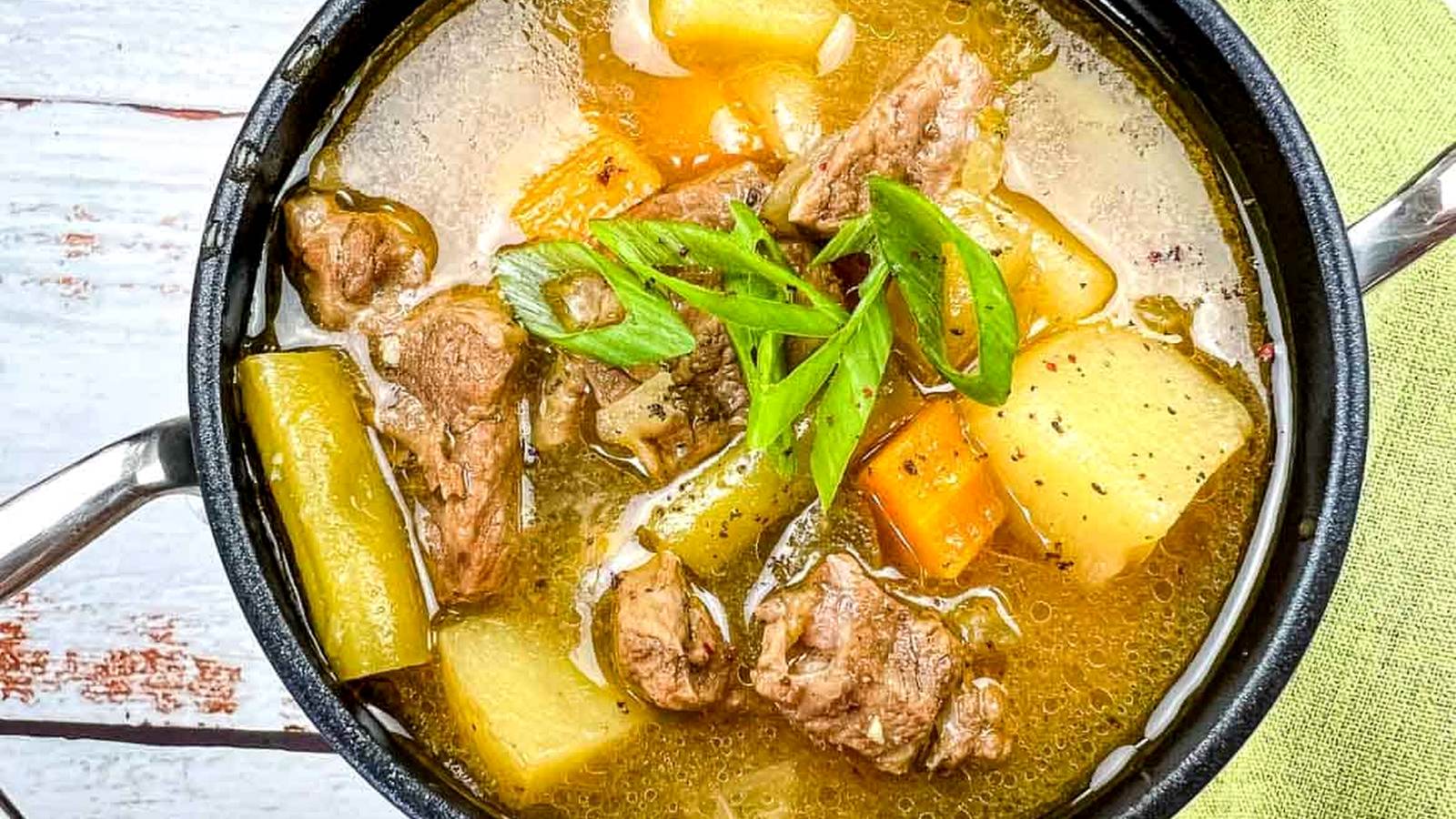 Steak & Potato Soup in a black bowl.