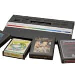 An Atari 2600 game console is shown with four game cartridges—Asteroids, Frogger, Missile Command, and Space Invaders—displayed on a white background, evoking classic Atari memories for retro gaming enthusiasts.