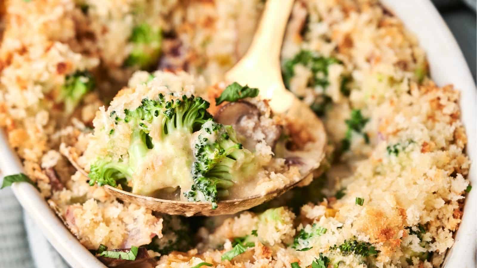 A baked casserole with a golden breadcrumb topping, garnished with fresh herbs.