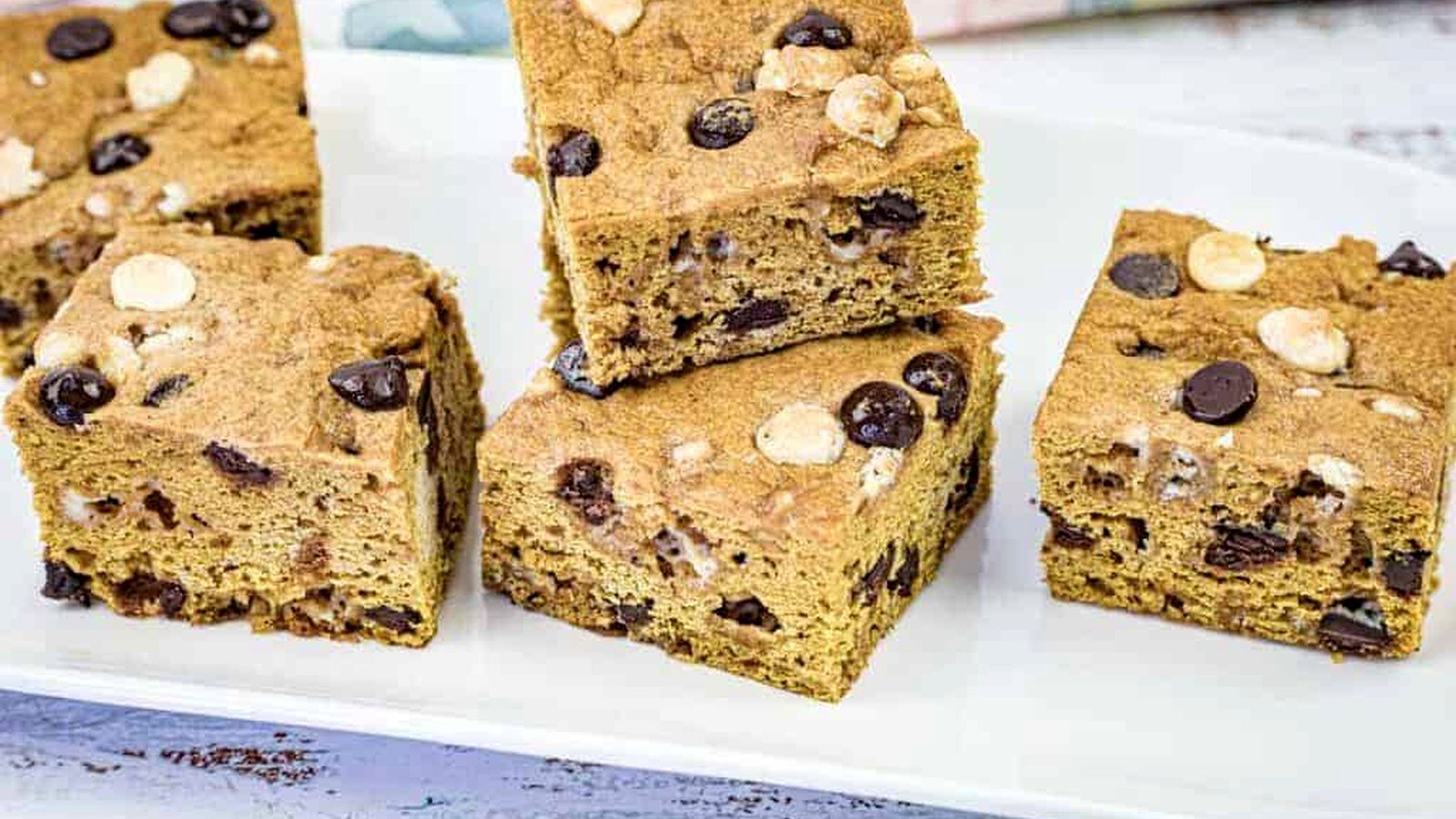 Close-up pumpkin blondies on a white plate.