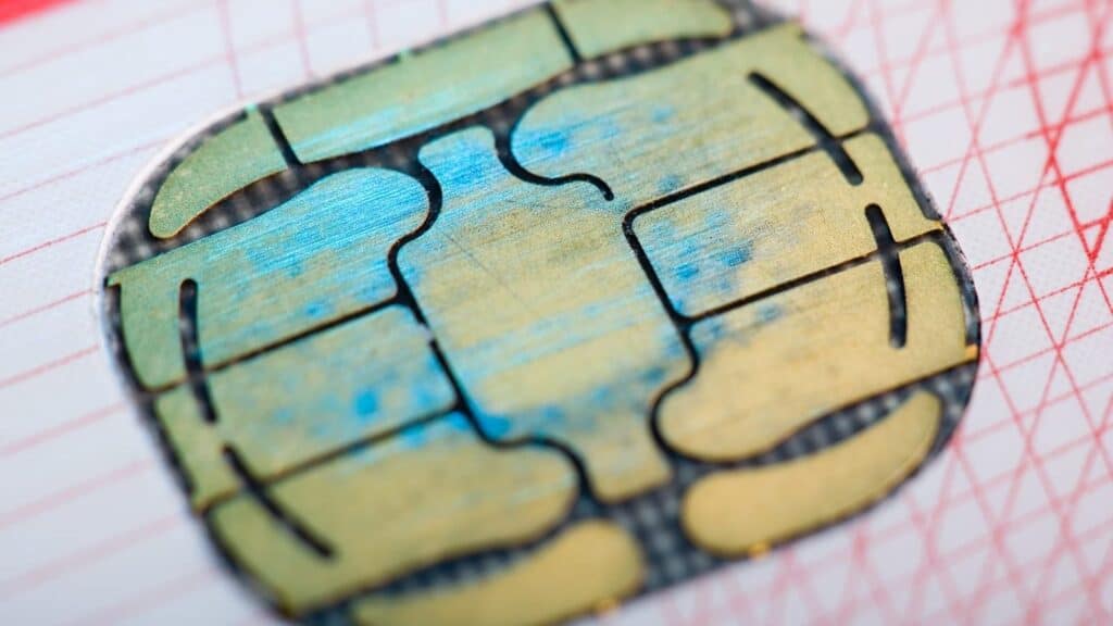 A close-up of a gold-colored electronic chip on a debit card, often checked when a transaction is declined abroad.