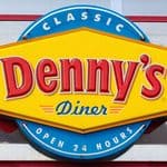 A Denny’s Diner sign with yellow, red, and blue colors reads “Classic Denny’s Diner Open 24 Hours,” mounted on a building exterior.