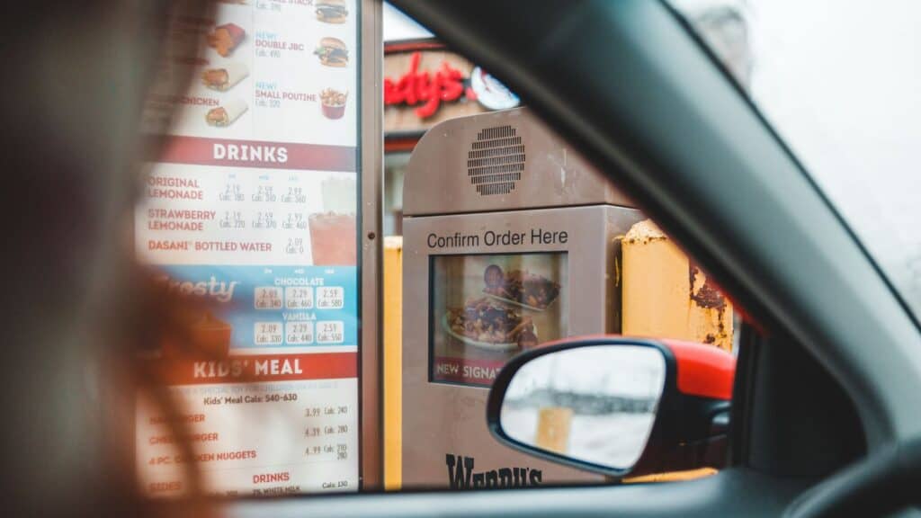 View from inside a car of a Wendy&rsquo;s drive-thru menu board and order kiosk, an innovation that changed the invention of the drive thru.
