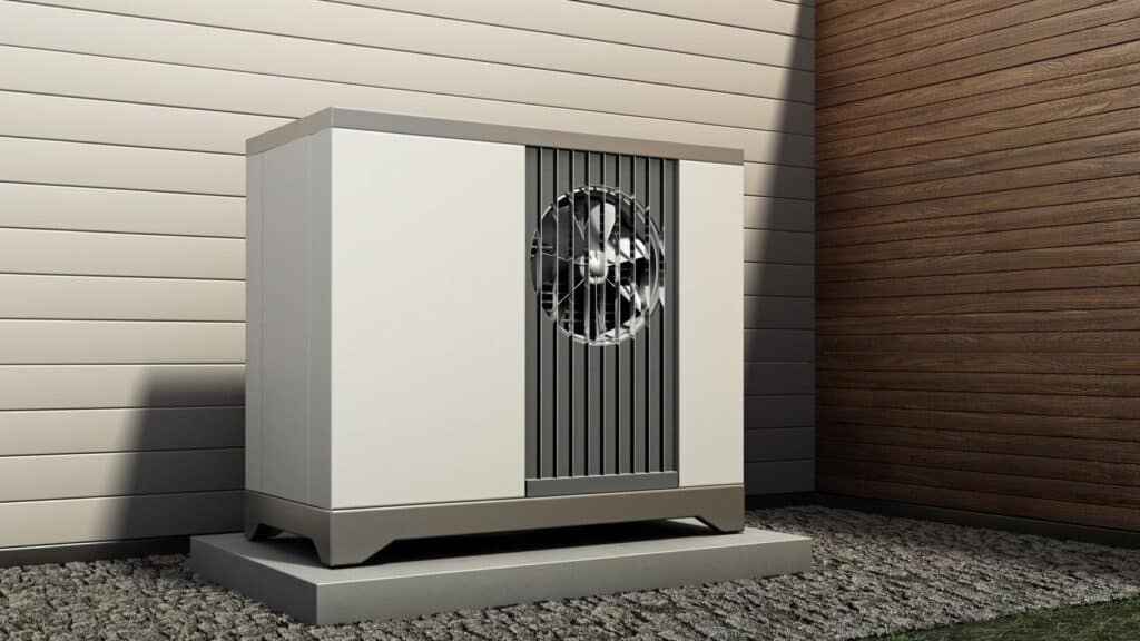 An outdoor heat pump unit on a concrete base against a building wall, reminding viewers of thermostat myths that won&rsquo;t save money.