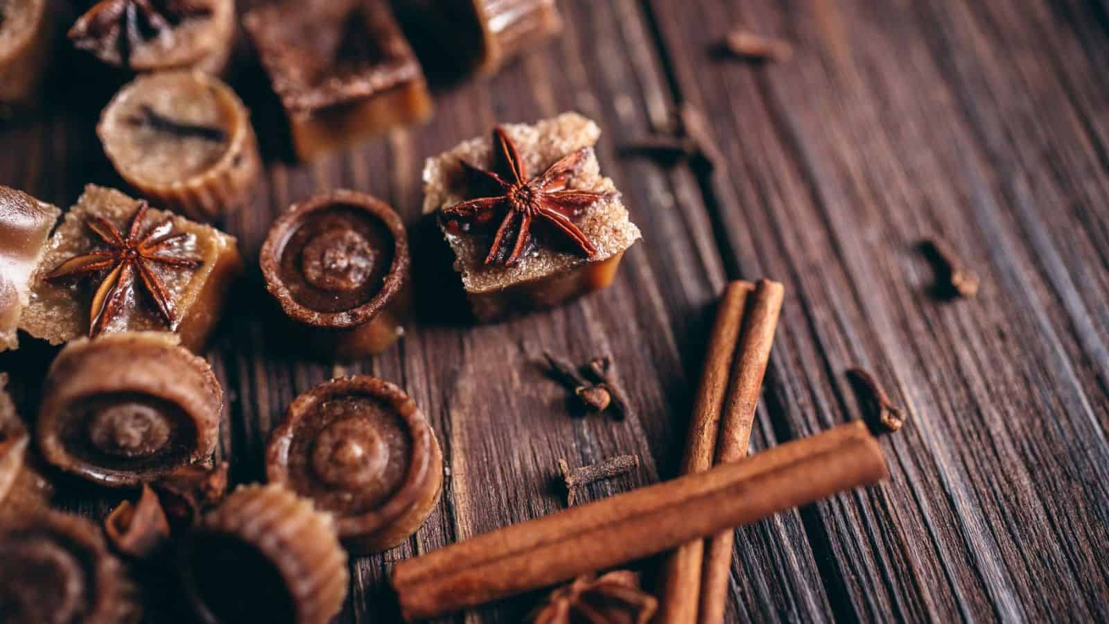 A chai bath melts recipe decorated with star anise, cinnamon sticks, and cloves on a wooden surface, evoking a cozy fall beauty routine.