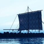 Silhouette of a Viking ship with a square sail on calm water.