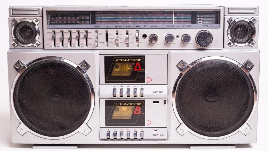 Silver double-cassette boombox that evokes boom box memories, featuring a radio tuner, equalizer sliders, and two large speakers.