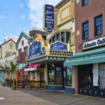A view of the Atlantic City boardwalk featuring James Salt Water Taffy, Atlantic Galleries, and other storefronts.